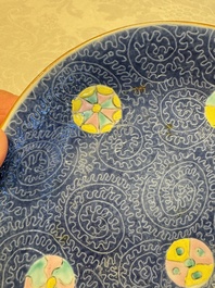 Four Chinese famille rose saucers and a gilt-decorated powder-blue-ground saucer, Qianlong and Jiaqing marks, 18/19th C.