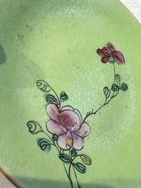 Four Chinese famille rose saucers and a gilt-decorated powder-blue-ground saucer, Qianlong and Jiaqing marks, 18/19th C.