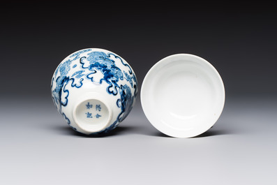 A Chinese blue and white 'Buddhist Lion' teapot, covered bowl and a saucer, various marks, 19th C.