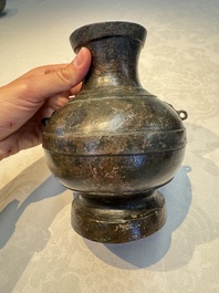 A miniature Chinese archaic bronze wine vessel with Taotie handles, 'Hu 壺', Han