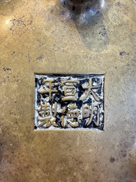 A Chinese bronze flower-shaped tripod censer with handles, Xuande mark, 19th C.