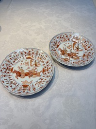 A pair of Chinese gilt iron-red-decorated 'Falconry' plates, Kangxi