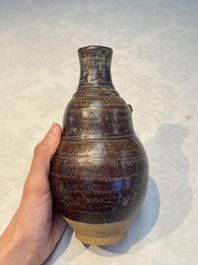 Three khmer-style brown-glazed anthropomorphic gourd-form bottles, probably 12/13th C.