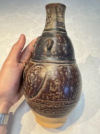 Three khmer-style brown-glazed anthropomorphic gourd-form bottles, probably 12/13th C.