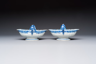 A pair of Chinese blue and white handled sauce boats and stands with pagodas along a river, Qianlong
