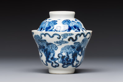 A Chinese blue and white 'Buddhist Lion' teapot, covered bowl and a saucer, various marks, 19th C.