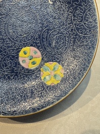 Four Chinese famille rose saucers and a gilt-decorated powder-blue-ground saucer, Qianlong and Jiaqing marks, 18/19th C.