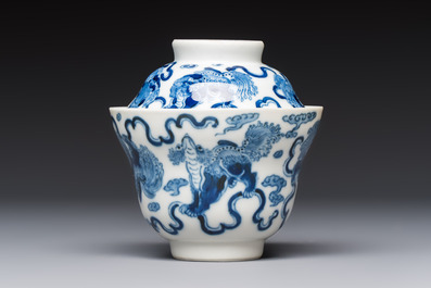 A Chinese blue and white 'Buddhist Lion' teapot, covered bowl and a saucer, various marks, 19th C.