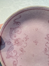 Four Chinese famille rose saucers and a gilt-decorated powder-blue-ground saucer, Qianlong and Jiaqing marks, 18/19th C.