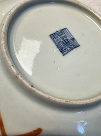 Four Chinese famille rose saucers and a gilt-decorated powder-blue-ground saucer, Qianlong and Jiaqing marks, 18/19th C.