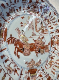 A pair of Chinese gilt iron-red-decorated 'Falconry' plates, Kangxi