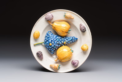 An unusual polychrome Swiss faience trompe l'oeil dish with various fruits, Winterthur, workshop of David Pfau II, 17th C.