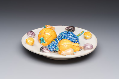 An unusual polychrome Swiss faience trompe l'oeil dish with various fruits, Winterthur, workshop of David Pfau II, 17th C.
