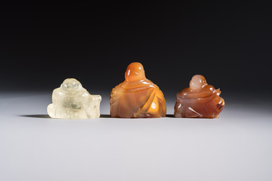 A Chinese carved rock crystal Milefo Buddha and two agate Milefo Buddhas, 19/20th C.