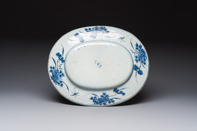 A very rare and massive blue and white Dutch Delft dish with peacocks in a garden, late 17th C.