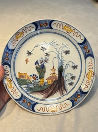 A blue and white Dutch Delft covered vase and two polychrome plates, 17/18th C.