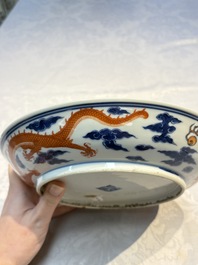 A Chinese blue and white iron-red-decorated 'Dragon' plate, Jing Jin Tang 精進堂 mark, 19th C.