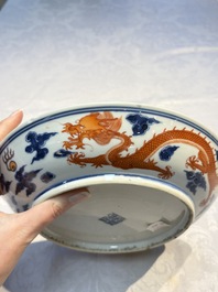 A Chinese blue and white iron-red-decorated 'Dragon' plate, Jing Jin Tang 精進堂 mark, 19th C.