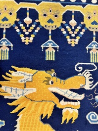 A Sino-Tibetan woollen 'Dragon' pillar carpet, 19th C.