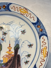 A blue and white Dutch Delft covered vase and two polychrome plates, 17/18th C.