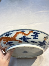 A Chinese blue and white iron-red-decorated 'Dragon' plate, Jing Jin Tang 精進堂 mark, 19th C.