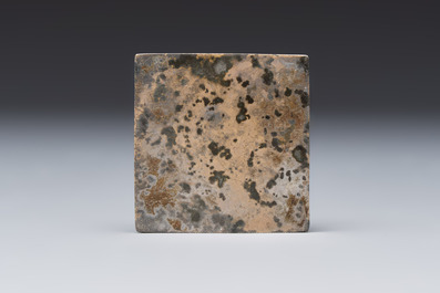 A small Chinese metal-alloy square mirror with relief design, Tang