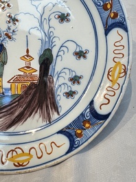 A blue and white Dutch Delft covered vase and two polychrome plates, 17/18th C.