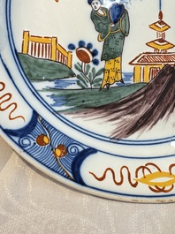 A blue and white Dutch Delft covered vase and two polychrome plates, 17/18th C.