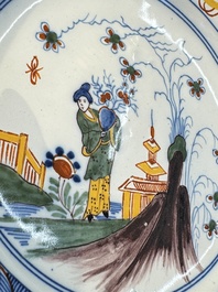 A blue and white Dutch Delft covered vase and two polychrome plates, 17/18th C.