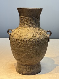 A Chinese archaistic bronze vase with Taotie handles, 'Hu 壺', Ming