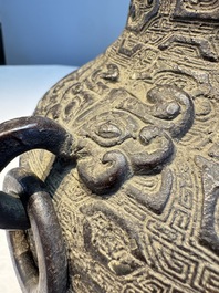 A Chinese archaistic bronze vase with Taotie handles, 'Hu 壺', Ming