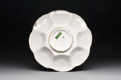 A blue, white and yellow Dutch Delftware dish with a putto, Delft or Haarlem, 17th C.