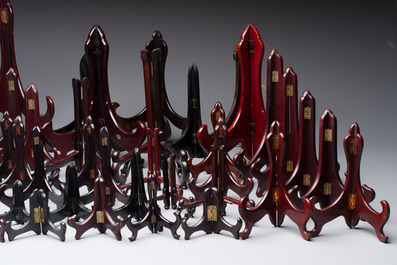 A collection of 75 Chinese folding wooden plate stands, 20th C.