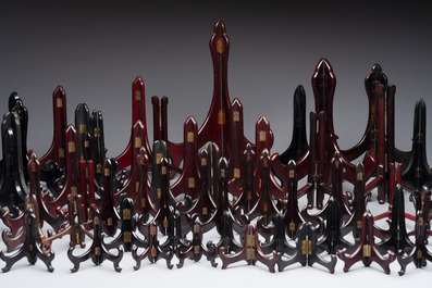 A collection of 75 Chinese folding wooden plate stands, 20th C.