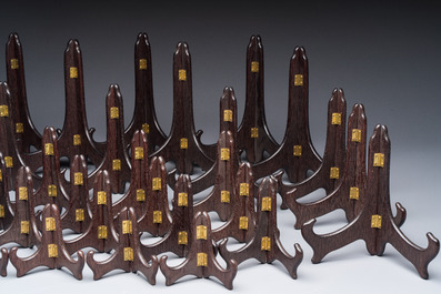 A collection of 35 Chinese wooden folding plate stands, 20th C.