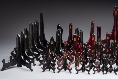 A collection of 75 Chinese folding wooden plate stands, 20th C.