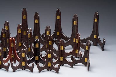 A collection of 35 Chinese folding wooden plate stands, 20th C.
