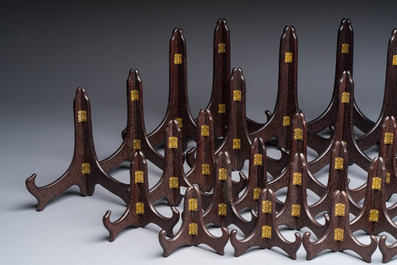 A collection of 35 Chinese wooden folding plate stands, 20th C.