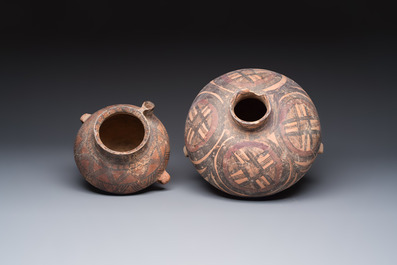 A Chinese painted pottery pouring vessel and a jar with geometric design, Neolithic period, Majiayao culture, 3rd millennium B.C.