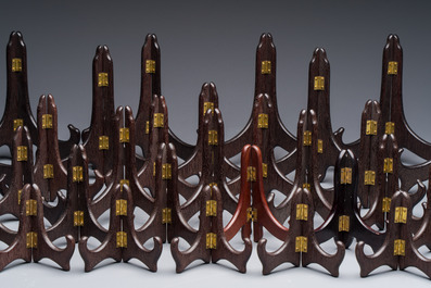 A collection of 35 Chinese folding wooden plate stands, 20th C.
