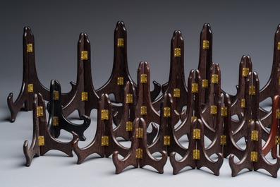 A collection of 35 Chinese folding wooden plate stands, 20th C.