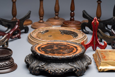 A collection of 21 wooden stands, 20th C.