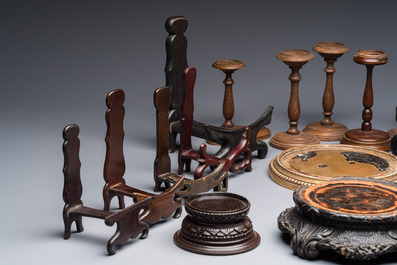 A collection of 21 wooden stands, 20th C.