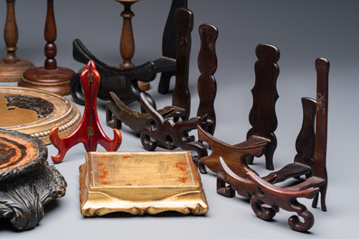 A collection of 21 wooden stands, 20th C.