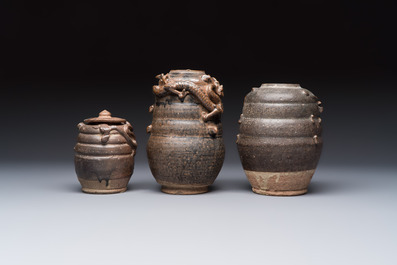 Three Chinese brown-glazed jars with an applied dragon design, one with cover, Song