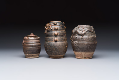 Three Chinese brown-glazed jars with an applied dragon design, one with cover, Song