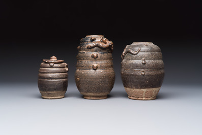 Three Chinese brown-glazed jars with an applied dragon design, one with cover, Song