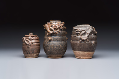 Three Chinese brown-glazed jars with an applied dragon design, one with cover, Song