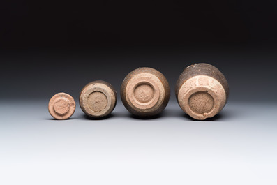 Three Chinese brown-glazed jars with an applied dragon design, one with cover, Song