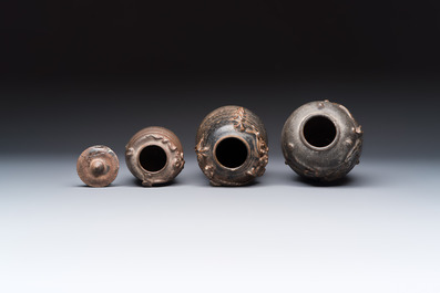 Three Chinese brown-glazed jars with an applied dragon design, one with cover, Song
